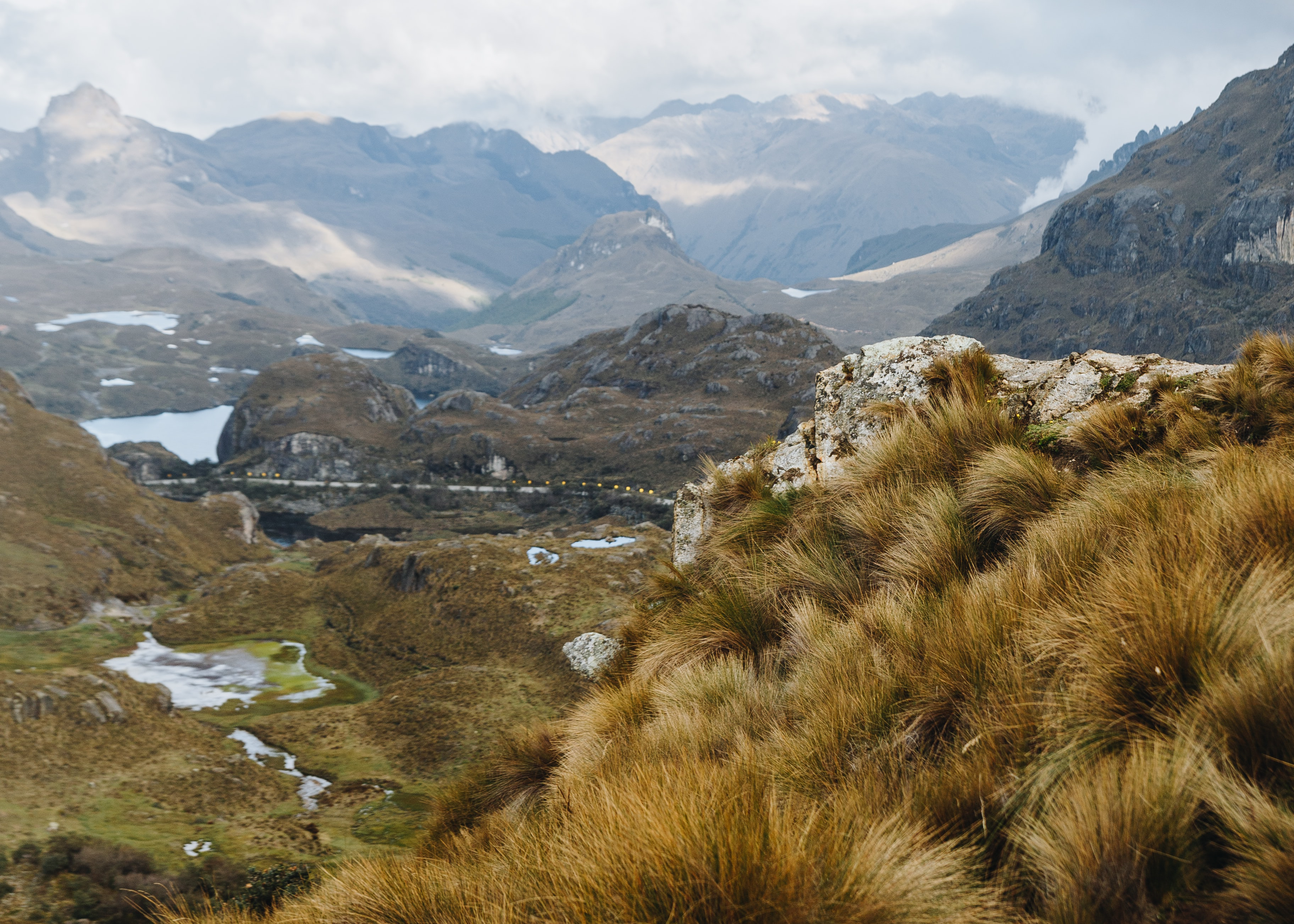 A lake at Cajas National Park with a mountain in the background